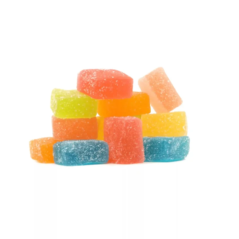 A colorful stack of sugar-coated, rectangular gummy candies is arranged against a plain white background. The candies come in various vibrant colors, including green, yellow, orange, red, and blue. Wondering how long do the effects of CBD gummies last?